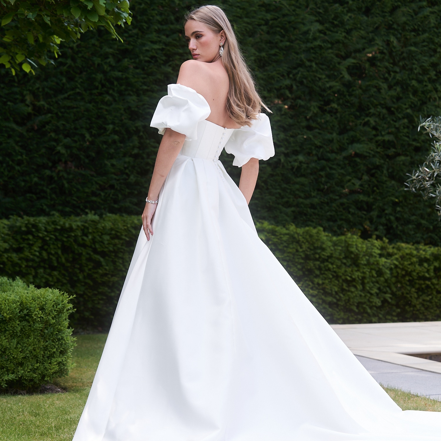 The Caroline Castigliano Tribute wedding gown is a breathtaking embodiment of modern bridal elegance. Handcrafted from luminous lightweight Italian Mikado silk, this masterpiece exudes an air of timeless sophistication. Find your dream wedding dress at Your Dream Bridal near Boston.