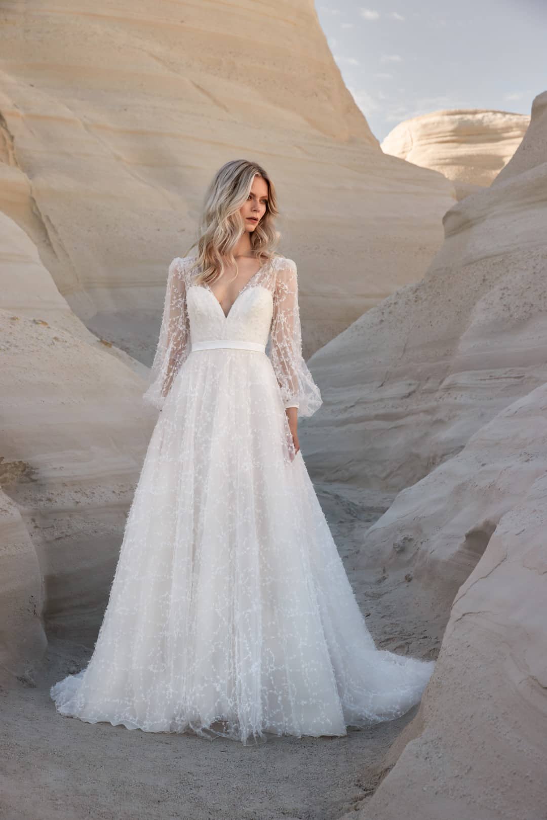 Sassi Holford Iris bow tulle wedding dress balances modernity with femininity, resulting in an endlessly flattering silhouette. Shop for your wedding dress at Your Dream Bridal Boston.