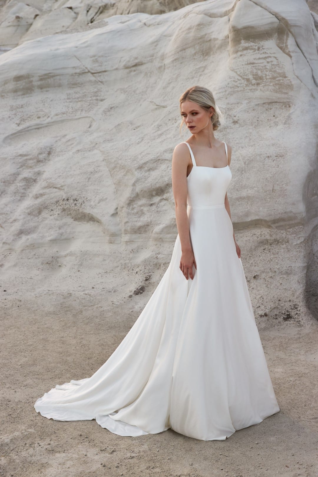 Sassi Holford Nina, crafted from the softest peau de soie, is simply stunning. A lightly corseted bodice is framed by elegant straps before flowing into a slim A-line skirt. A low square feature back finishes this timeless design. Shop for your wedding dress at Your Dream Bridal Boston.